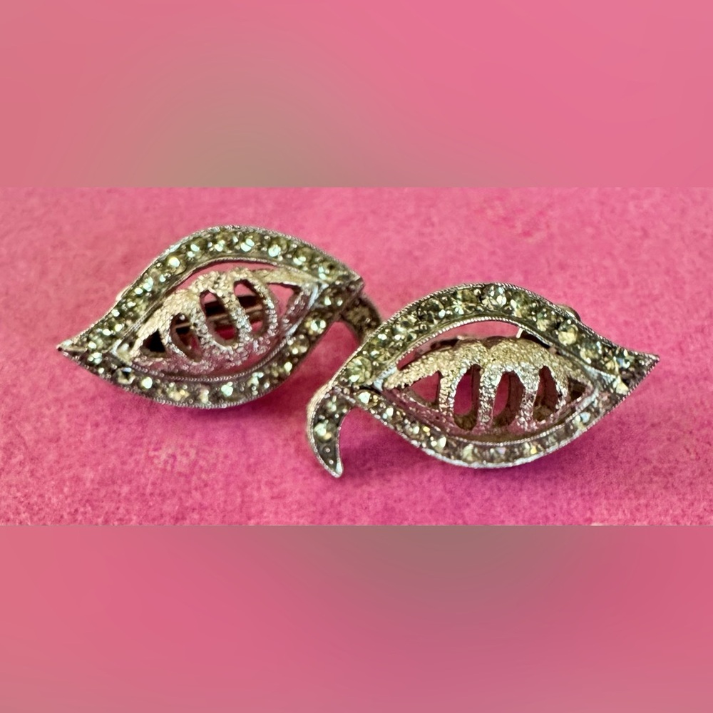 Vintage rhinestone clip on earrings signed “Tradition”.